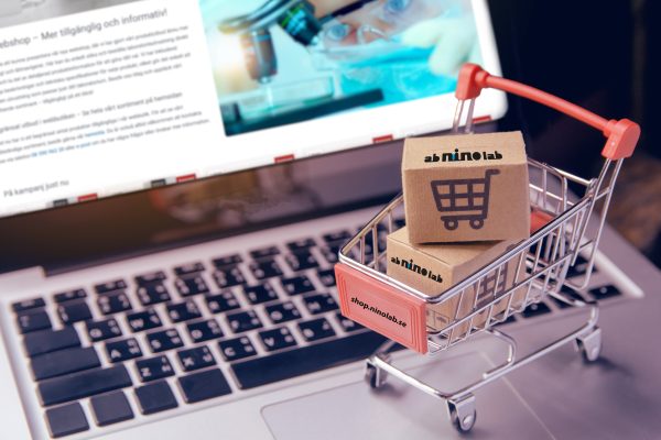 Shopping online concept - Parcel or Paper cartons with a shopping cart logo in a trolley on a laptop keyboard. Shopping service on The online web. offers home delivery.